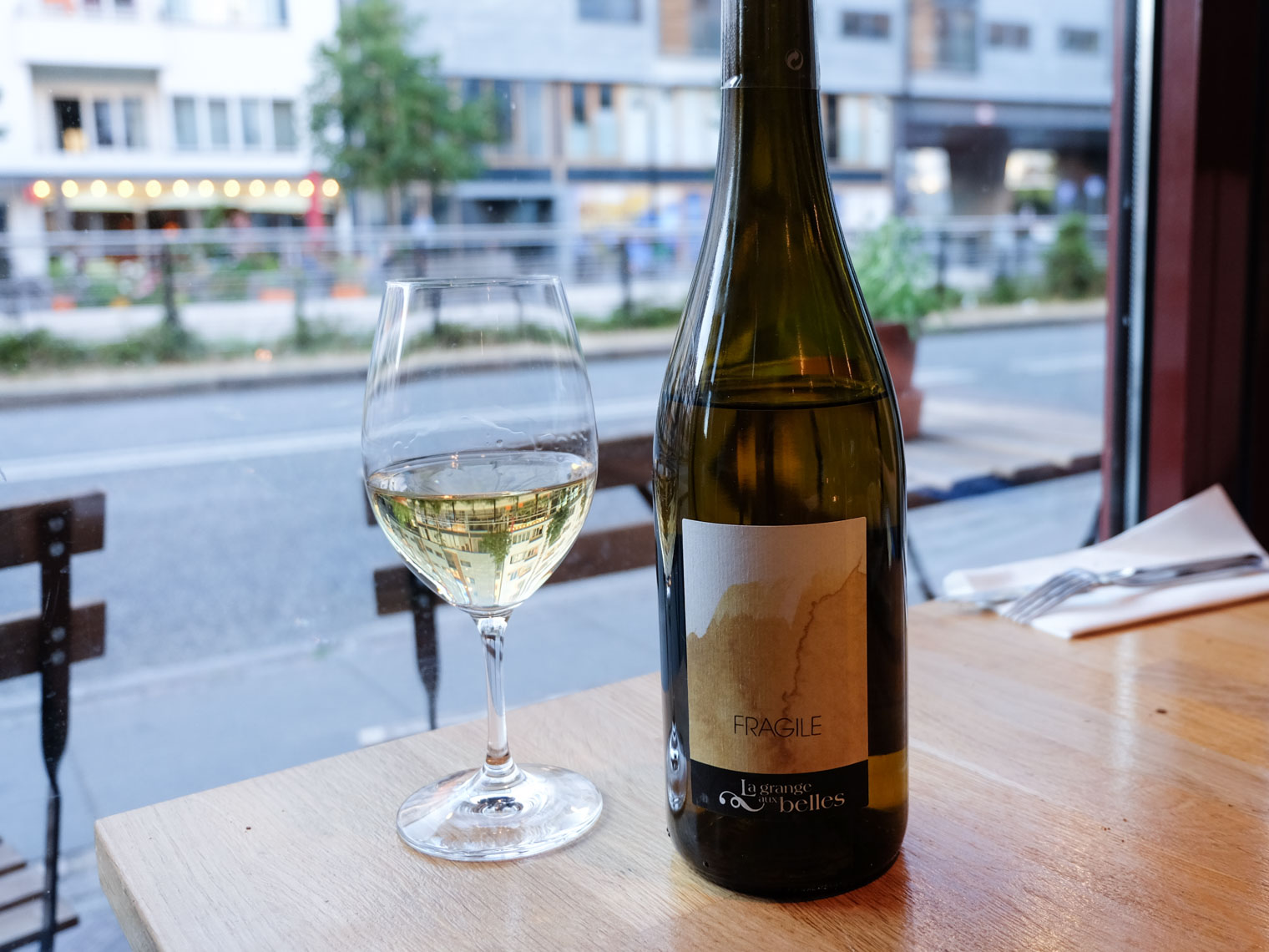 Flaske og glas hvidvin ved vinduet hos Restaurant Pondus i Aarhus