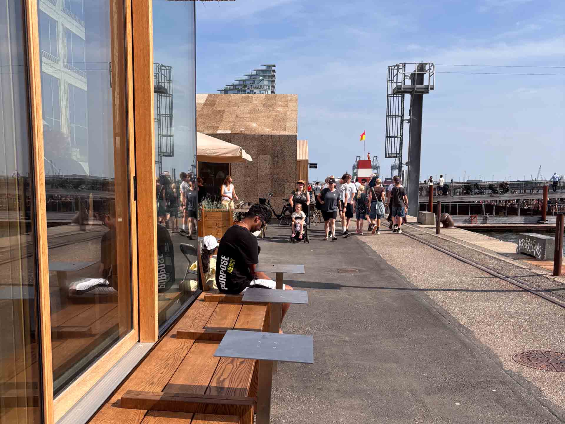 Bænk langs facaden med udsigt til havnen hos Hakko på Aarhus Ø